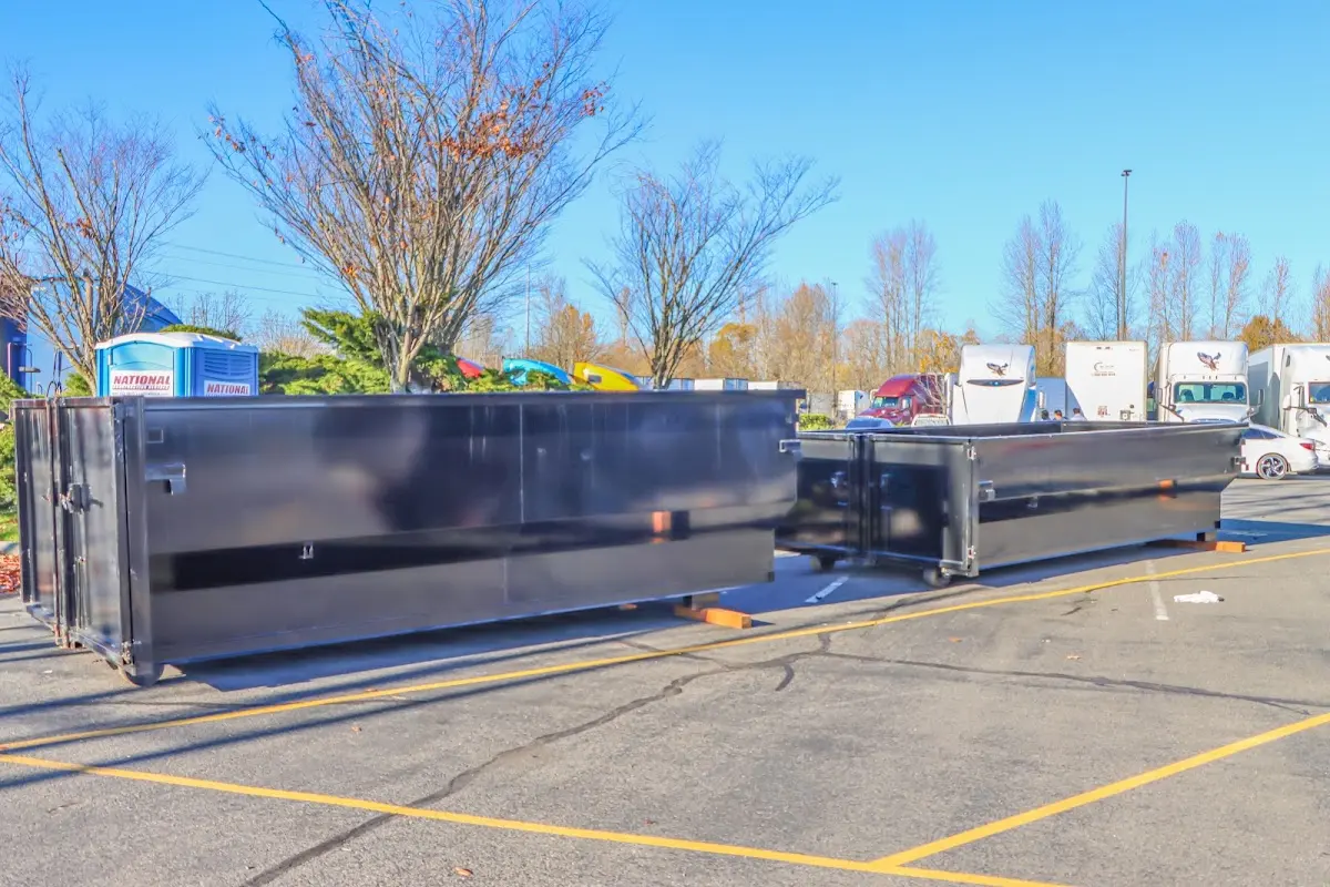 Professional dumpster rental service with roll-off container on residential driveway in Cameron